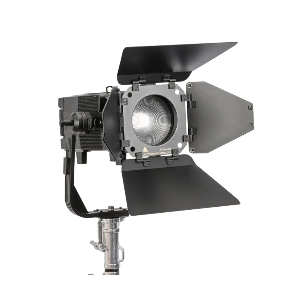 Astera Leo Fresnel front view showing fresnel lens with barndoors, yoke mount and chrome stand adapter, white background