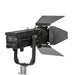 Astera Leo Fresnel rear side view showing control panel with LED display and buttons, ventilation grille, barndoors, yoke mount and stand adapter, white background