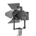 Astera Pluto Fresnel rear view showing LED display, connectors, control panel, barndoors, yoke mount and stand adapter, white background