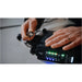 Astera QuikBeam NetBox in use with hands connecting cable to front panel showing green and amber status LEDs lit lifestyle shot