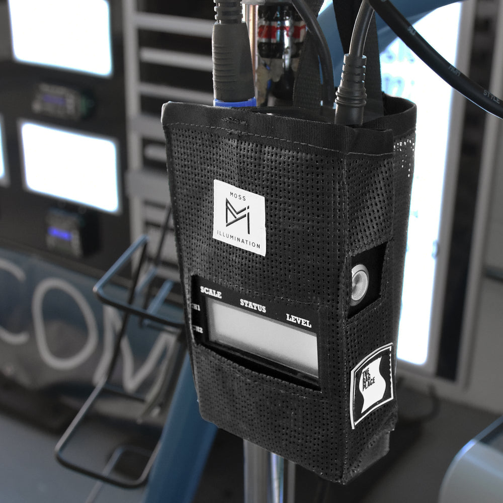 Moss Illumination MI Fixture PSU holder mounted on lighting stand in studio environment showing LuxBox V3 controller installed with cables connected professional film set
