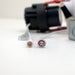 Moss LED 3-Inch Recessed Downlight Dim-To-Warm close-up of quick-connect cable connectors showing male and female pin configurations white circular plugs with downlight body blurred in background