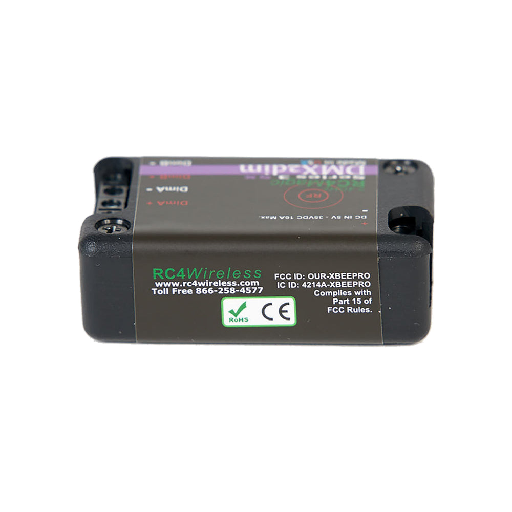RC4Magic S3 DMX2dim 2-channel wireless dimmer bottom label view showing FCC, CE, and RoHS compliance markings, RC4Wireless contact information, black housing, white background