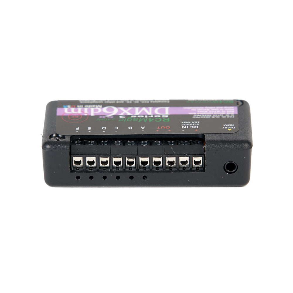 RC4 Wireless RC4Magic Series 3 DMX6dim 6-channel wireless dimmer bottom view showing Phoenix connector slots for 6 output channels DC power jack and status LED openings on black compact housing on white background