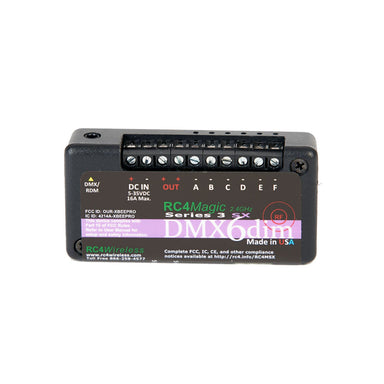 RC4 Wireless RC4Magic Series 3 DMX6dim 6-channel wireless dimmer front angle view showing screw terminals for channels A B C D E F DC IN 5-35VDC 16A DMX RDM data port RC4Magic 2.4GHz branding Made in USA on black compact housing on white background