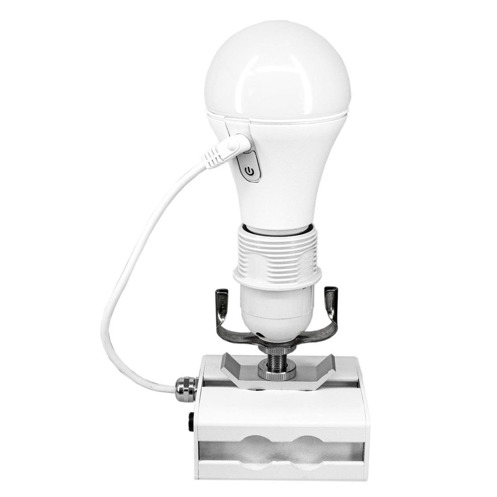 Astera NYX Bulb mounted on CupBouncer accessory with USB charging cable connected, white background
