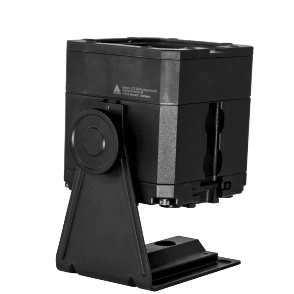 Astera PB15 PixelBrick side rear angle view showing black compact LED light housing with battery compartment safety label tilt adjustment knob and mounting bracket base plate for professional wireless film and event lighting on transparent background