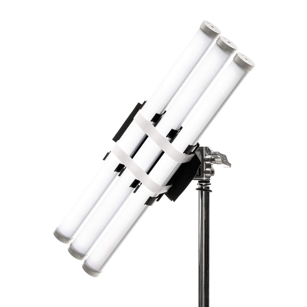 Astera softbox adapter SBAAT22 close-up angle view showing multiple Titan LED tube lights mounted in black bracket holder with white velcro straps securing tubes on chrome light stand for professional film and studio lighting on white background