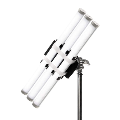 Astera softbox adapter SBAAT22 close-up angle view showing multiple Titan LED tube lights mounted in black bracket holder with white velcro straps securing tubes on chrome light stand for professional film and studio lighting on white background
