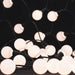 Moss LED globe LED string lights warm white frosted round bulbs close-up illuminated showing decorative patio and event lighting on dark background