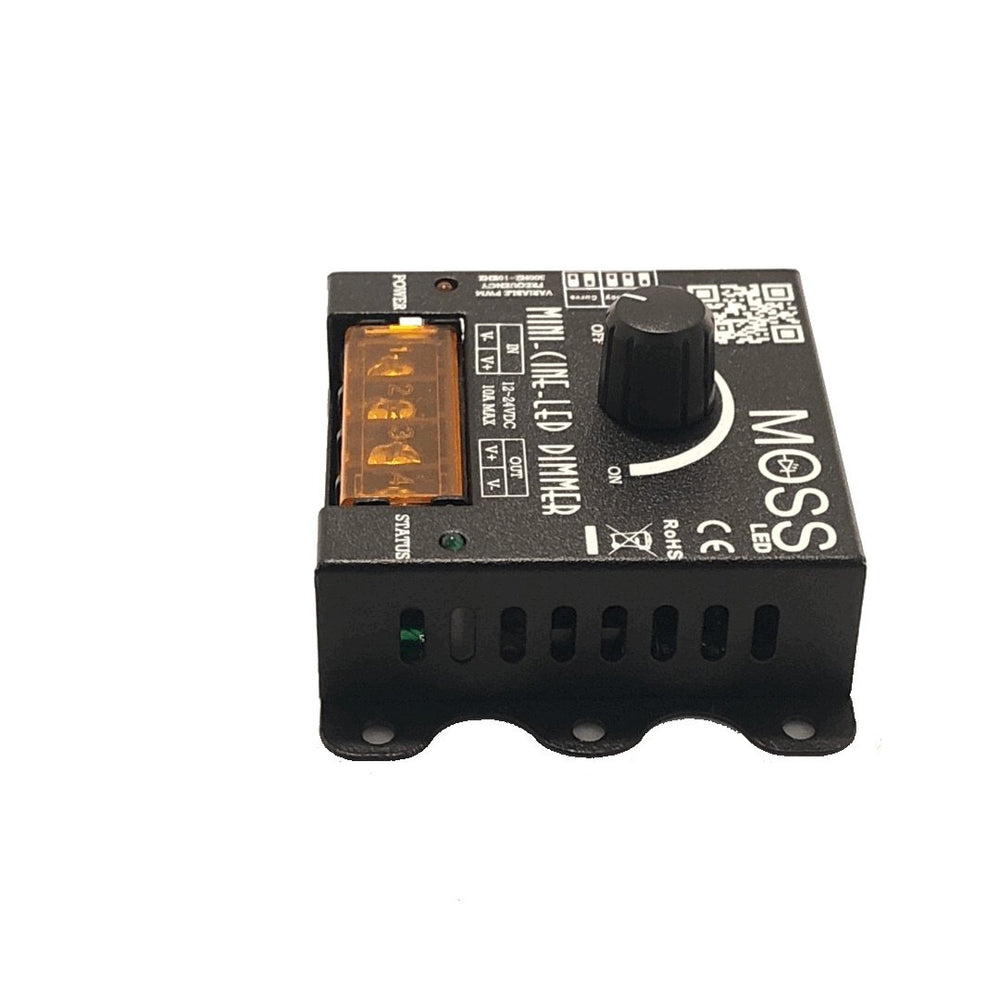 Moss LED Mini-Cine single channel rotary dimmer V2 front angle view showing ventilation panel green status LED orange terminal block and rotary dimmer knob on white background