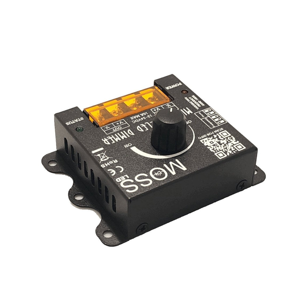 Moss LED Mini-Cine single channel rotary dimmer V2 side angle view showing ventilation slots orange terminal block and rotary knob black metal enclosure with QR code
