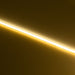 aMoss LED SoftFLEX Slim LED 528 2700K warm white 12V lit LED strip running diagonally on dark background