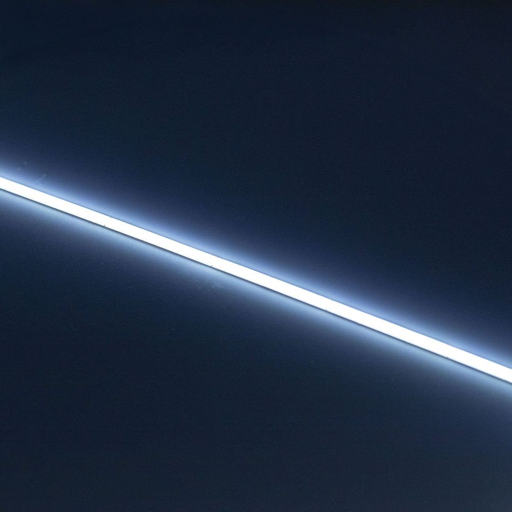 aMoss LED SoftFLEX Slim LED 528 6500K cool white 12V lit LED strip running diagonally on dark background