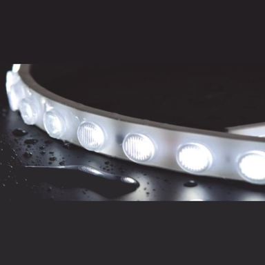 Moss LED SpotFlex LED 48 white strip light illuminated close-up showing lensed LEDs glowing bright white on dark wet surface for focused beam lighting