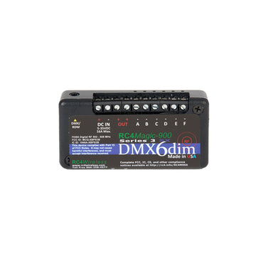 RC4 Wireless RC4Magic-900 Series 3 DMX6dim 6-channel wireless DMX dimmer front view showing black compact housing with detailed FCC compliance labels DMX RDM input DC IN power connector screw terminal outputs A through F red green status LEDs RC4Magic-900 Series 3 branding DMX6dim logo and Made in USA badge on white background